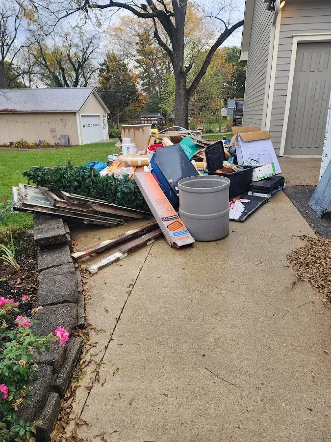 Dumpster being loaded with debris for Roofing Dumpster Rental in Houston